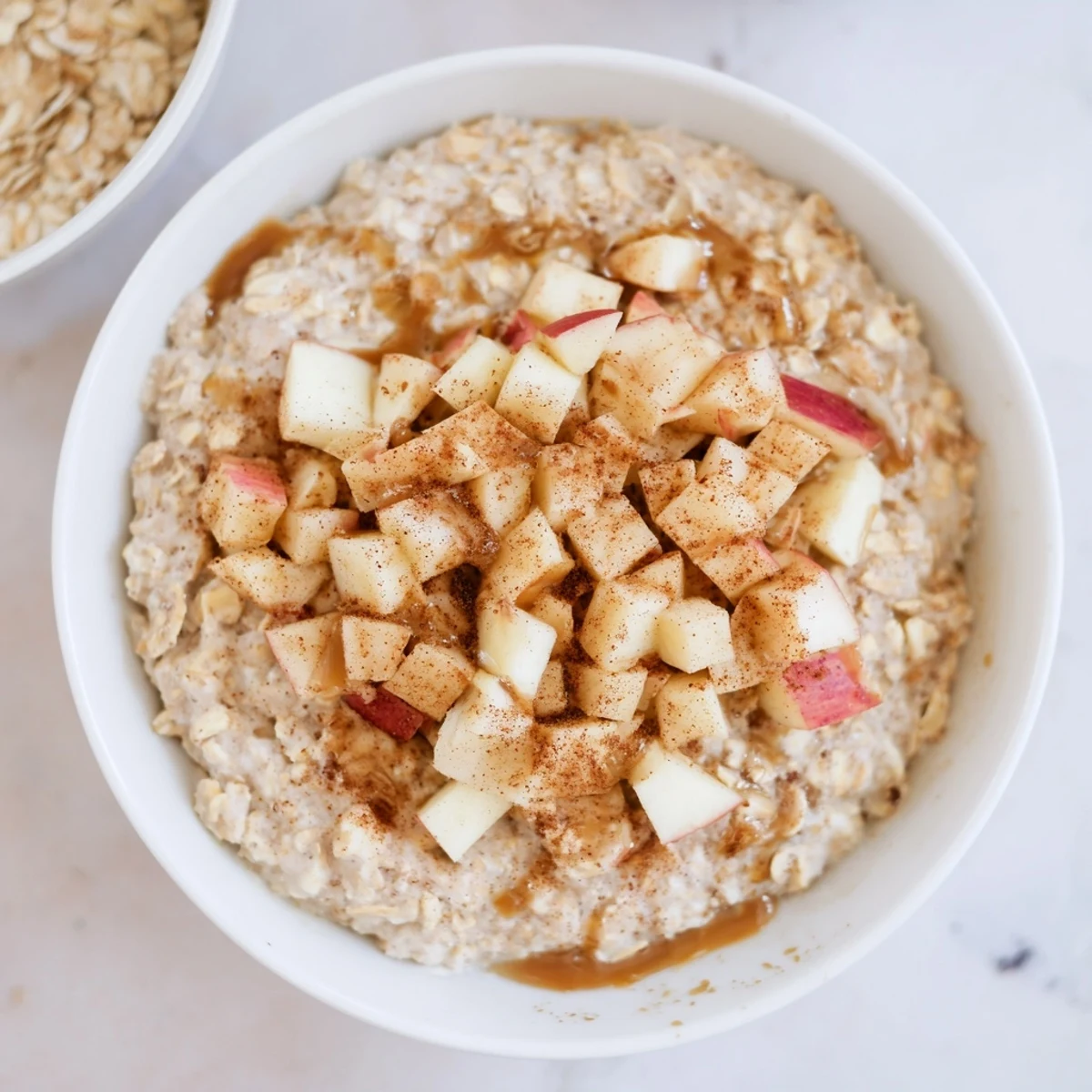 Creamy Apple Pie Overnight Oats topped with fresh diced apples and cinnamon.  