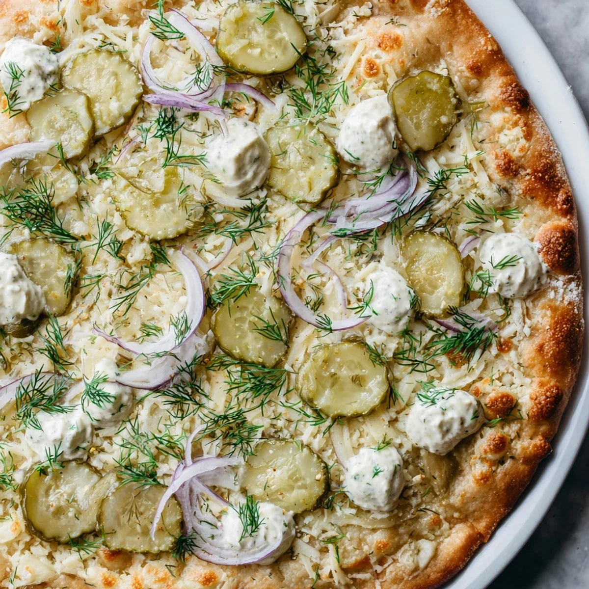 Savor a slice of pickle pizza featuring rich crème fraîche and golden crust.
