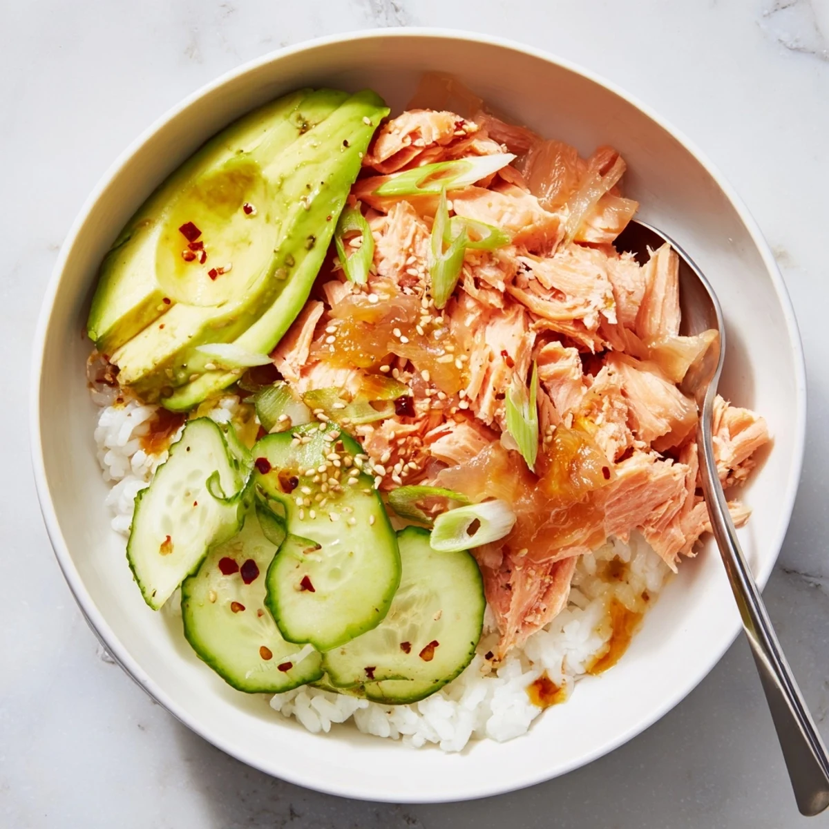 Delicious Leftover Salmon & Rice Bowl topped with fresh avocado, cucumber, and ginger.  