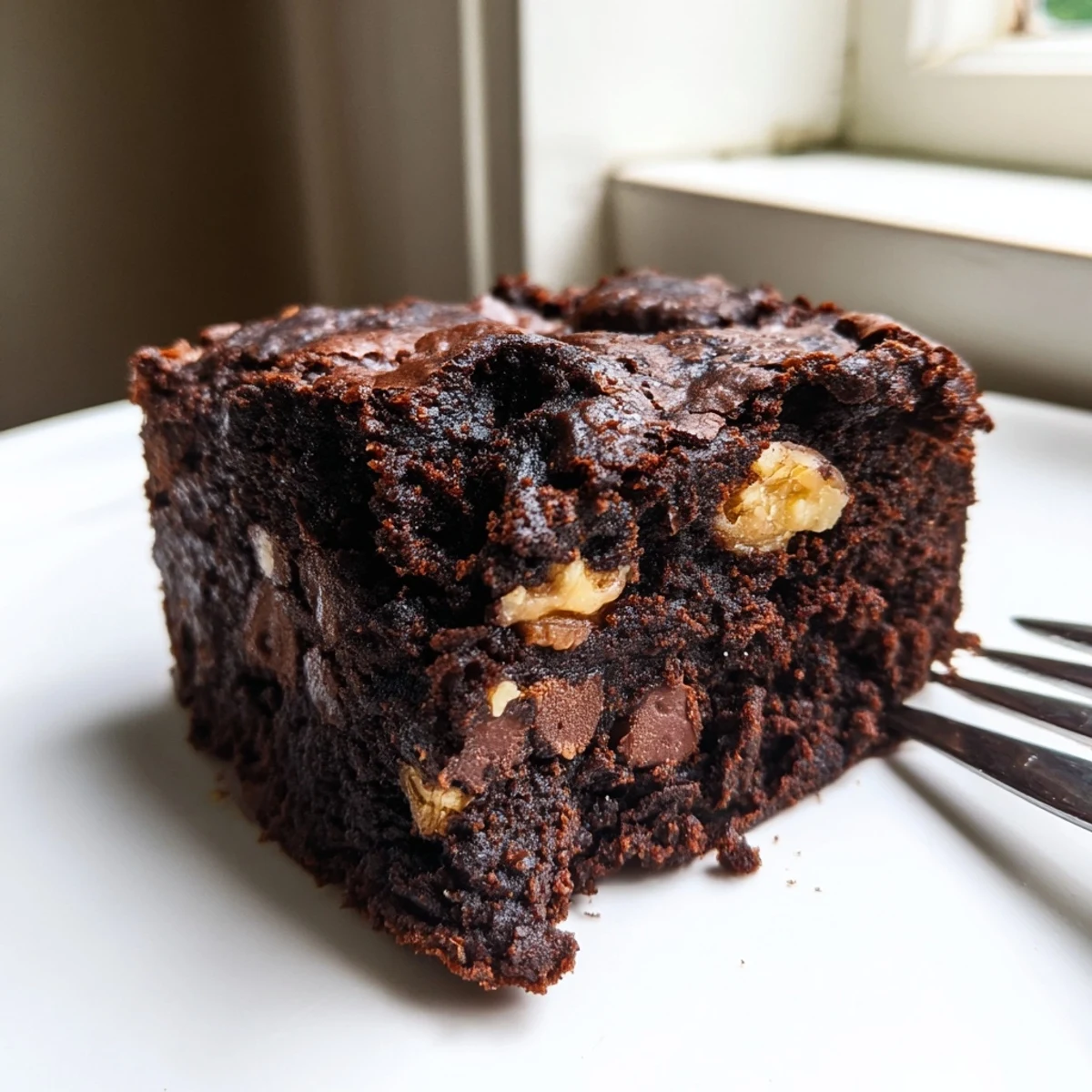 Rich zero-waste brownies using nut-milk pulp, drizzled with melted chocolate.  