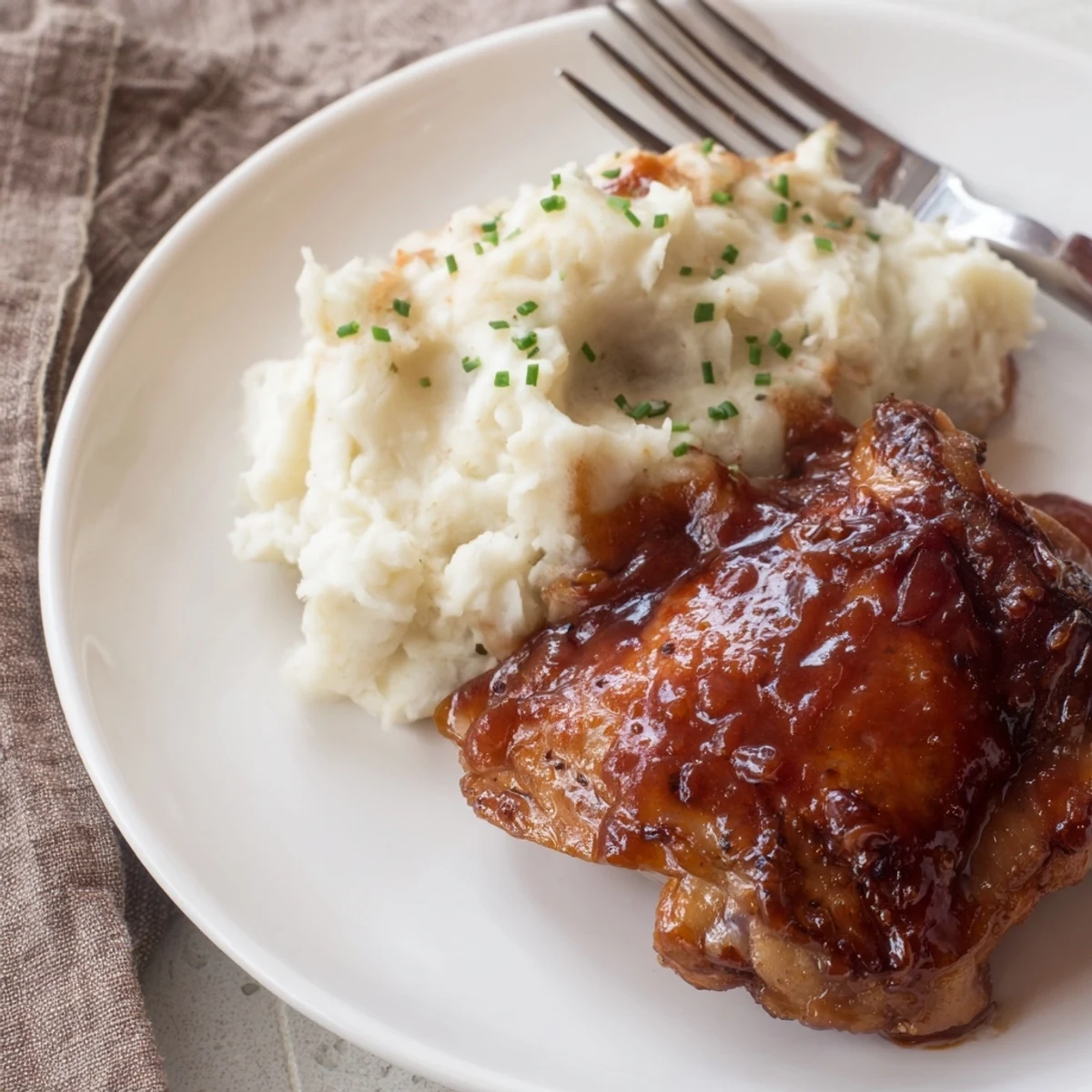 Succulent honey BBQ chicken thighs served with buttery garlic mashed potatoes.  
