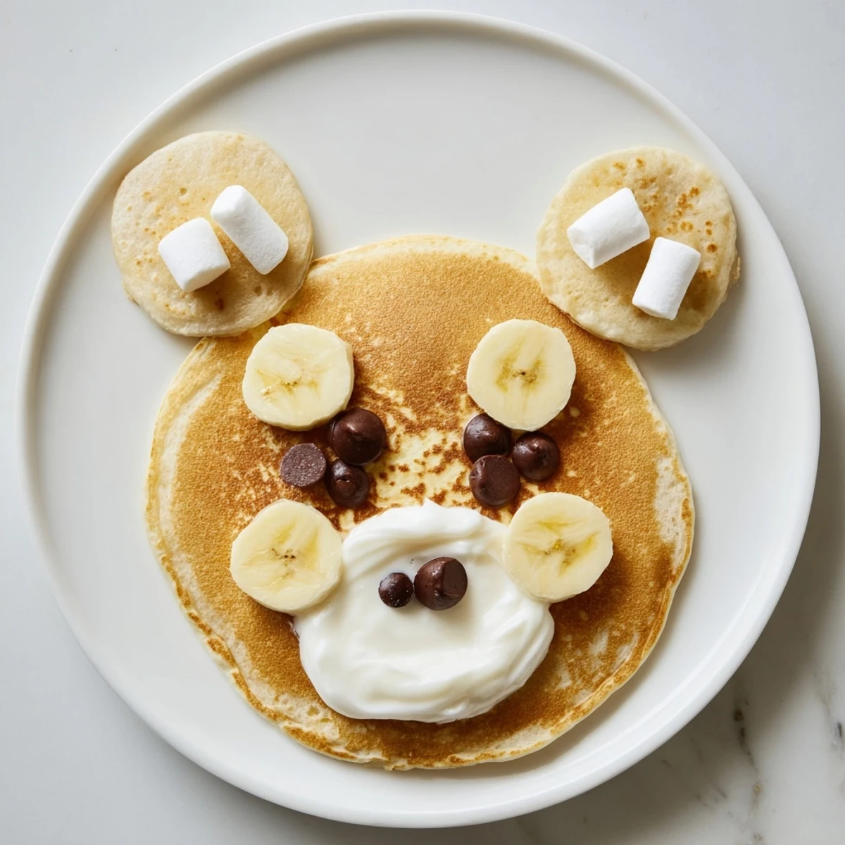 Sweet, homemade Polar Bear Pancakes stacked high, surrounded by fruit, whipped cream, and syrup; a perfect breakfast.