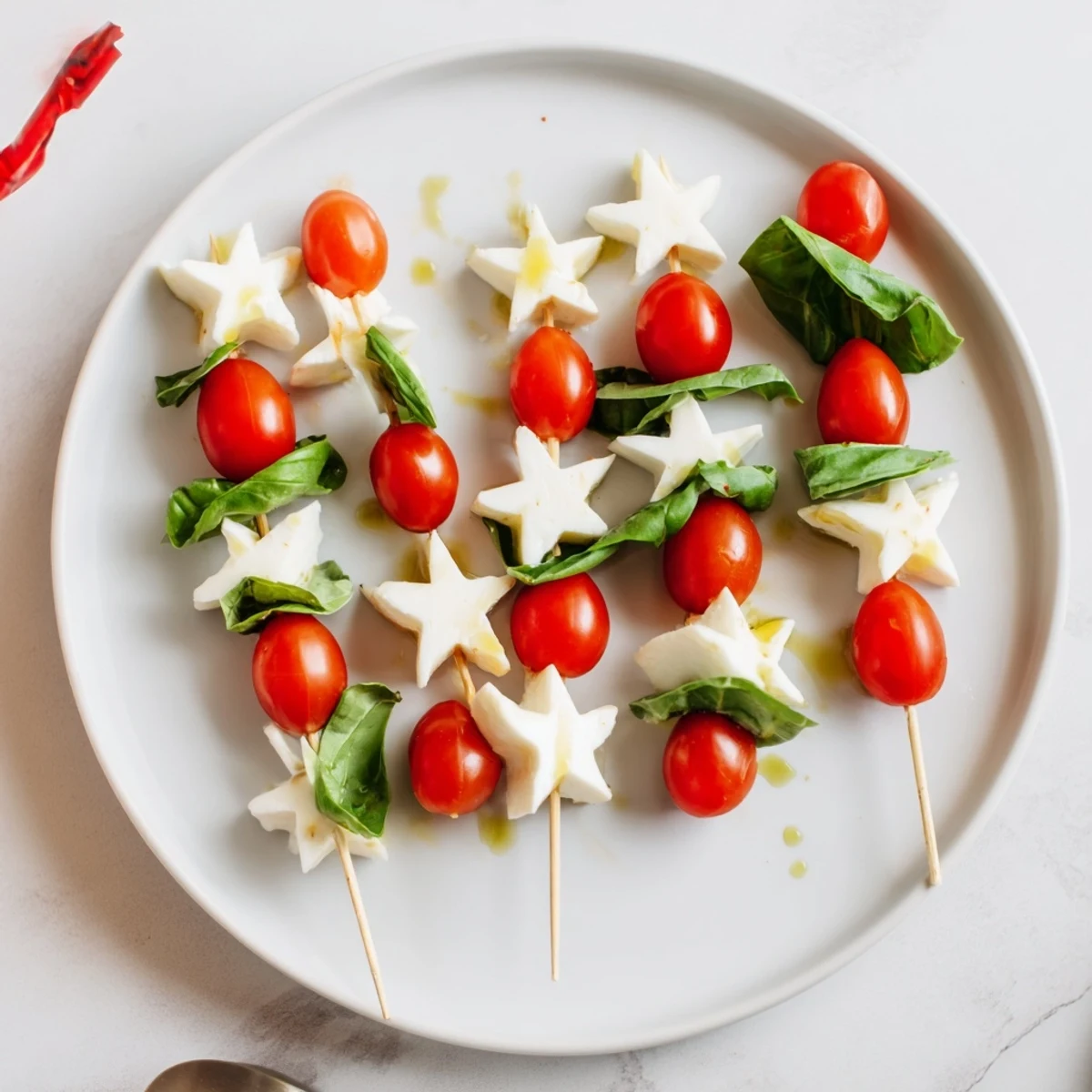 Star-shaped Caprese skewers drizzled with balsamic glaze, a colorful and easy appetizer bursting with Italian flavors.