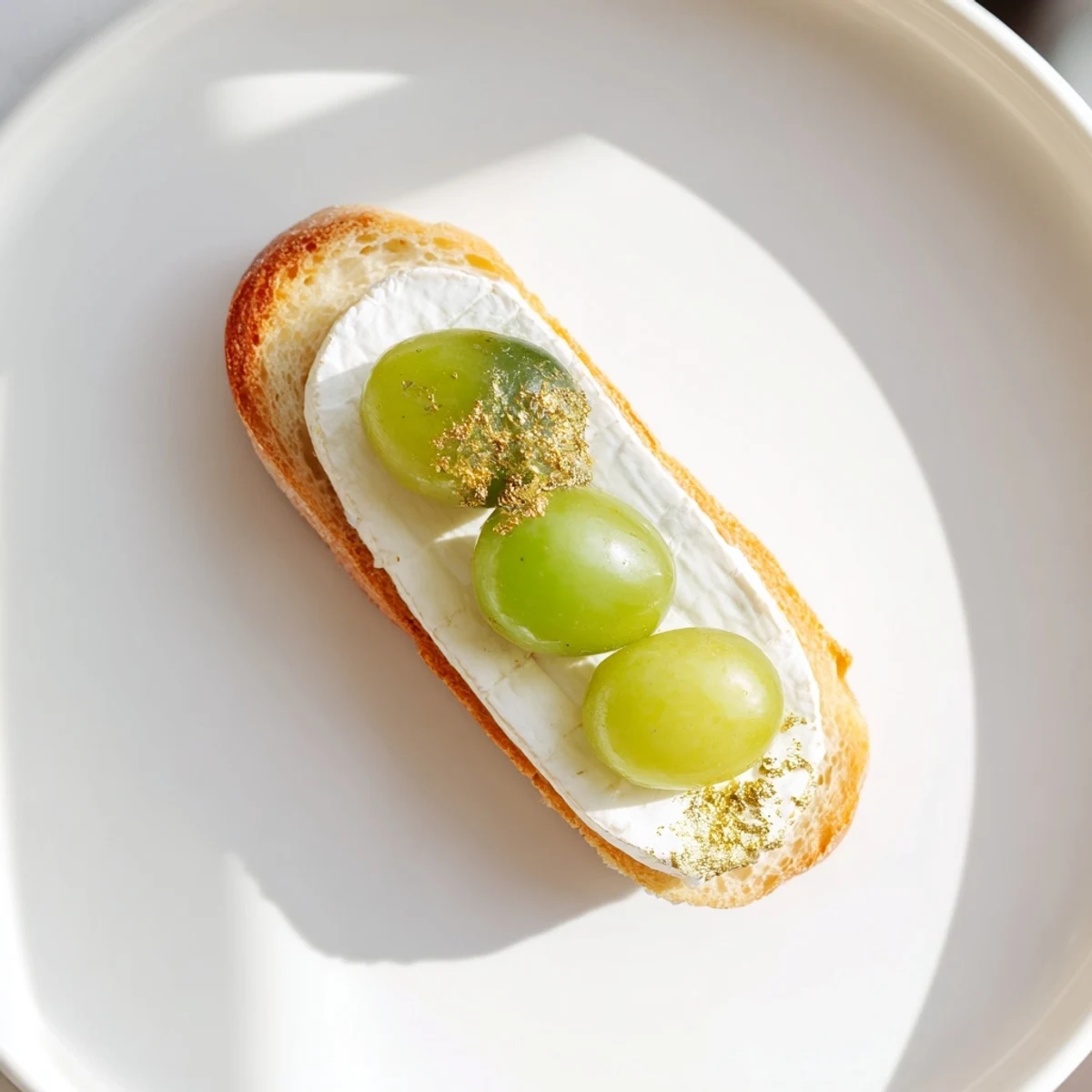Golden glistening Sparkling Champagne Toast appetizers are ready, featuring prosecco-soaked grapes and creamy cheese.