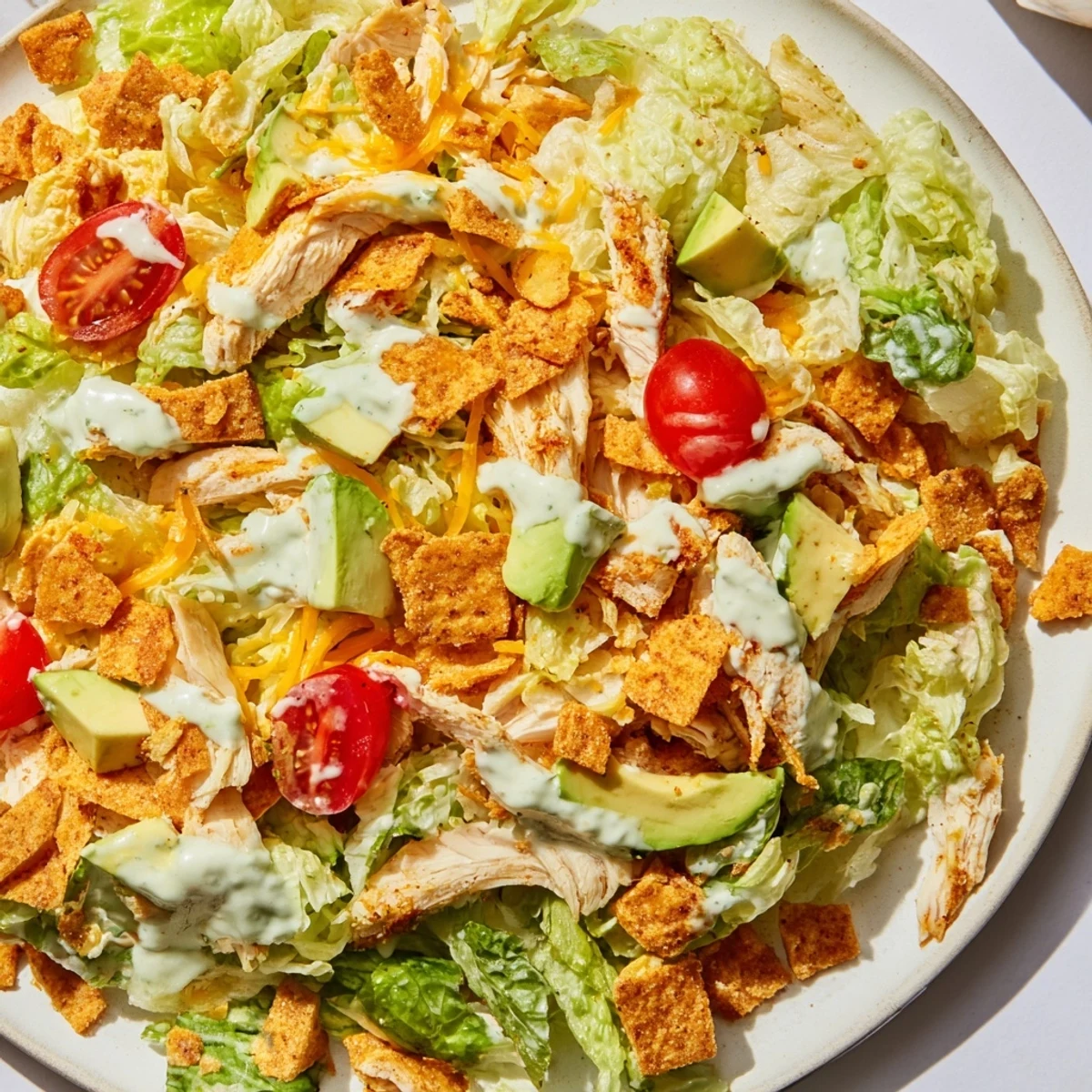 Serving suggestion for crunchy taco chicken salad, a Tex-Mex main dish with vibrant veggies and a zesty sour cream lime dressing.