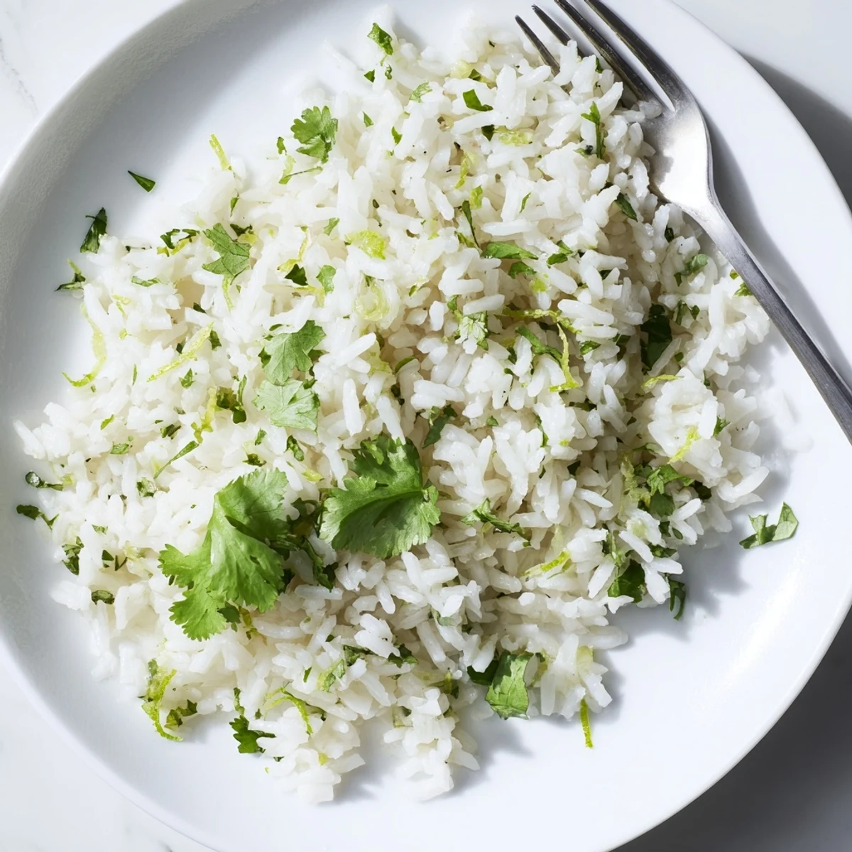 Zesty cilantro lime rice garnished with lime wedges, a fragrant vegan side perfect for weeknight Mexican-inspired dinners.