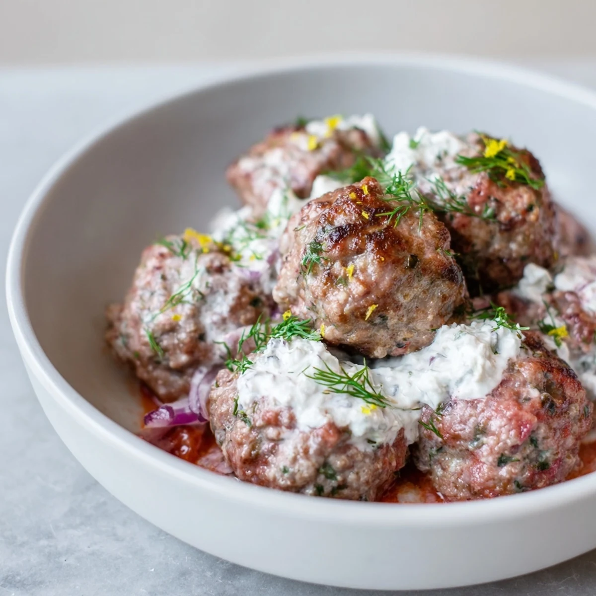 A close-up shot of the Instant Pot Greek Meatballs, showcasing their juicy texture and delicious feta topping.