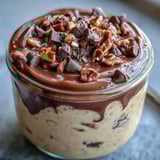 This thick and creamy peanut butter cup overnight oats breakfast is topped with mini chocolate chips and served chilled in glass jars.