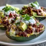Perfectly ripe avocado halves cradle warm, spiced taco beef, melted cheddar, and fresh salsa.