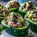 Freshly scooped cucumber boats overflowing with zesty tuna and creamy avocado salad, ready for a quick 10-minute lunch.