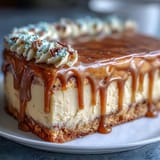 Showstopping graduation cake features a smooth buttercream base topped with a shimmering gold drip and fondant mortarboard.