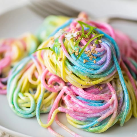Vibrant Neon Noodle Cloud in creamy sauce, perfect for colorful party meals.  