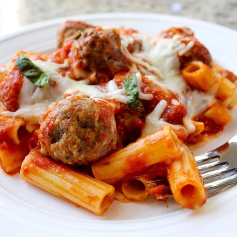 Hearty Italian Meatball Pasta Skillet topped with melted mozzarella and fresh basil.  
