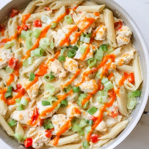Steaming, one-pan Buffalo Chicken Pasta Skillet, with melted cheese and tender chicken, a family favorite.
