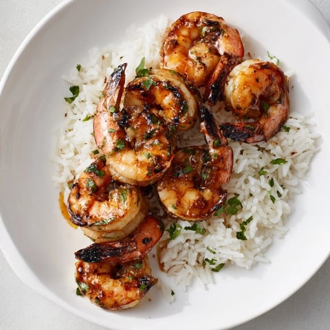 Smoky chipotle lime grilled shrimp atop vibrant cilantro rice, a flavorful and healthy meal.