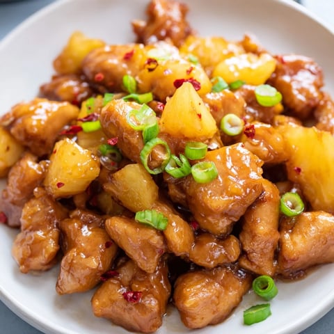 Golden-brown Brown Sugar Pineapple Chicken, glistening with a sweet glaze, ready to serve over rice.