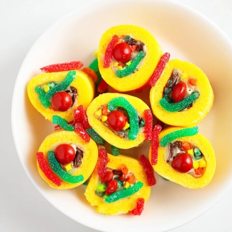 Festive Christmas Fruit Rollup Sushi rolls with colorful candies; imagine the yummy, chewy textures.