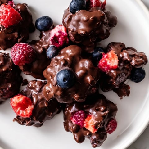 Dark chocolate coating a fresh berry-filled Chocolate Yogurt Cluster for a cool, refreshing treat.