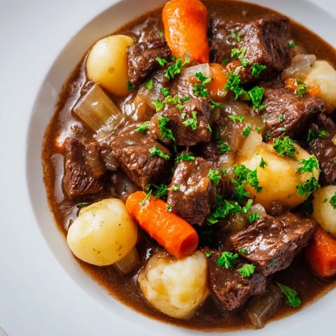 Chunks of tender beef and vegetables swim in a rich, savory broth of the Irish Beef Stew.