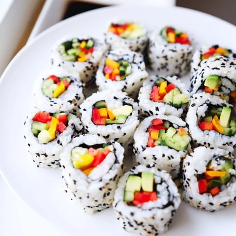 Colorful bite-sized Festive Holiday Snack Sushi Rolls on a platter, perfect for gatherings.  