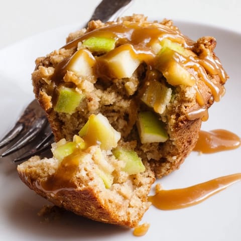 Freshly baked caramel apple sourdough muffins filled with apples, perfect for snacks.  