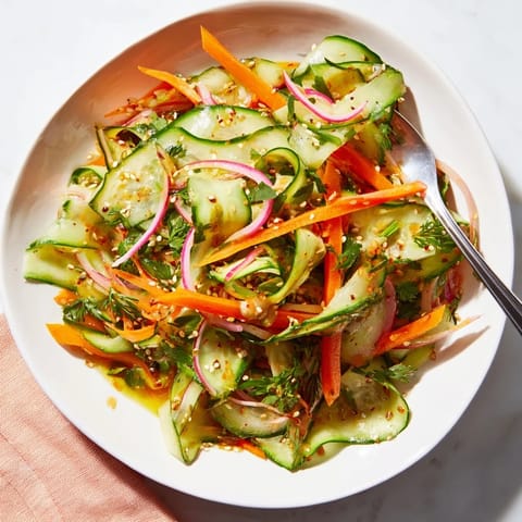 Vibrant cucumber salad remix with colorful veggies and a zesty dressing.  