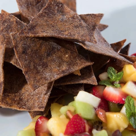 Delicious Dessert Chips & Salsa showcase a sweet twist with vibrant, fresh fruit toppings.  