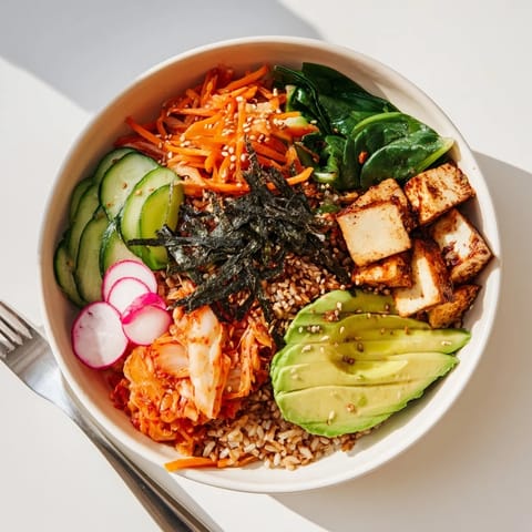 Delicious fermented vegetable bowl topped with avocado, vibrant vegetables, and sesame seeds.  