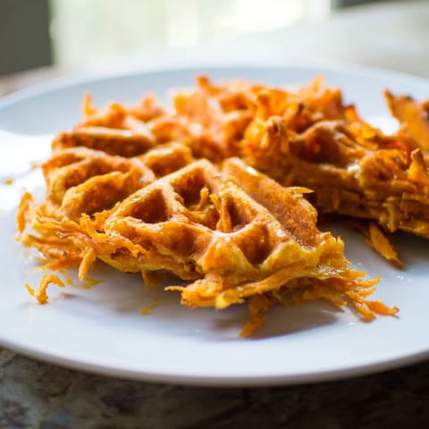 A stack of fluffy Sweet Potato Waffle Hack, showcasing a quick and easy breakfast idea.
