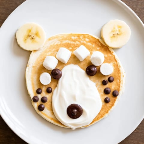 A beautifully arranged Polar Bear Pancake Stack with mini marshmallow ears and chocolate chip eyes, ready for serving!
