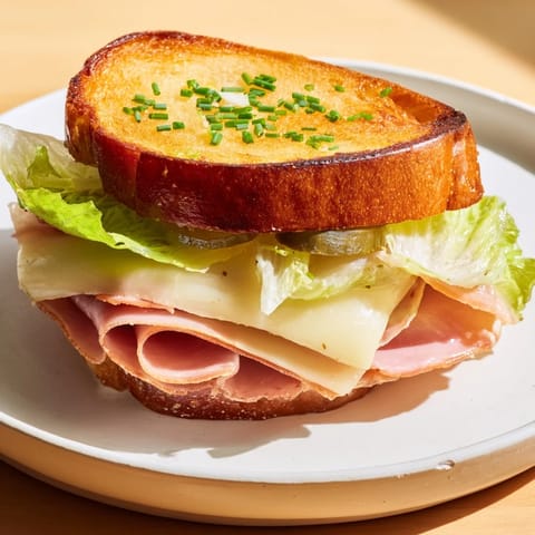 Festin du Château Royal Sandwiches platter with layers of elegant meats, cheeses, and fresh greens, ready to enjoy.