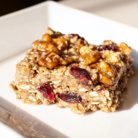 Deliciously moist maple cinnamon oatmeal bars featuring visible oats and delightful, warm spices.