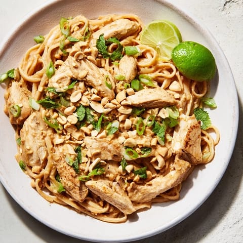 Creamy Thai Peanut Chicken Pasta in a bowl, showcasing chicken and pasta coated in sauce.