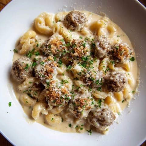 Creamy and cheesy Mac & Cheese Meatball Bake, topped with golden breadcrumbs, ready to serve and enjoy.