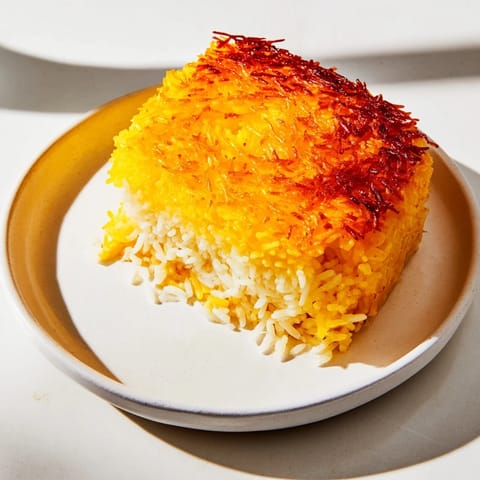 A close-up of a perfectly formed Persian Tahdig rice, showcasing a crunchy, caramelized crust and tender rice.