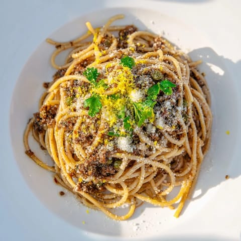 Freshly made Olive Tapenade Pasta with vibrant green parsley, ready to be enjoyed.