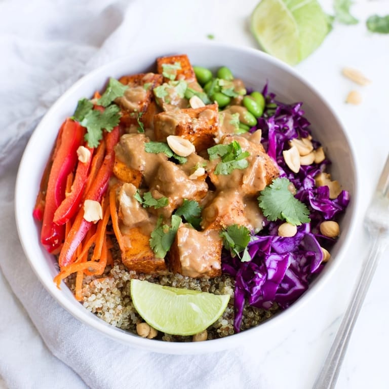 Colorful Thai Peanut Roasted Sweet Potato Bowl recipe: satisfying vegan lunch with cilantro garnish.