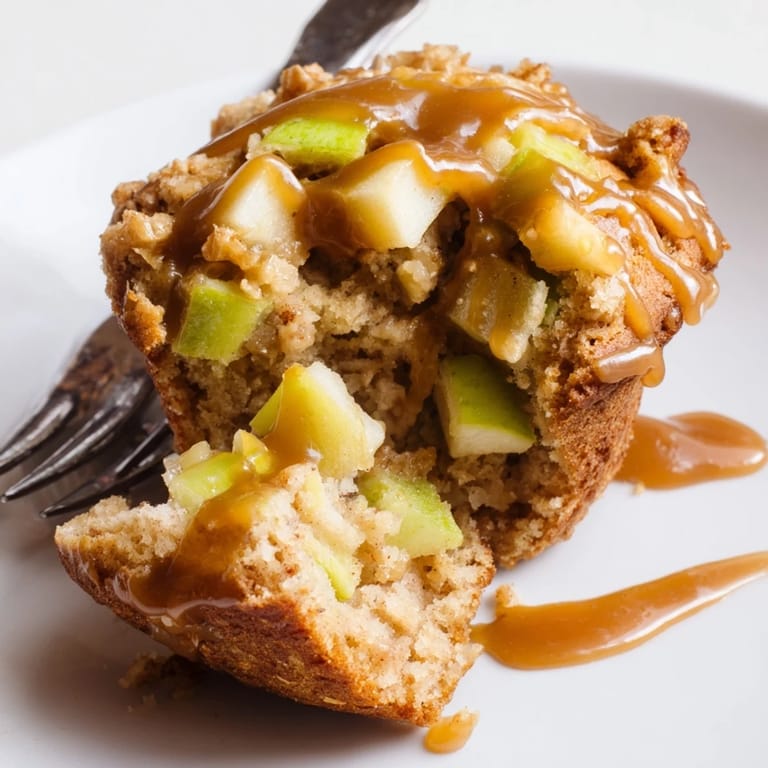 Freshly baked caramel apple sourdough muffins filled with apples, perfect for snacks.  
