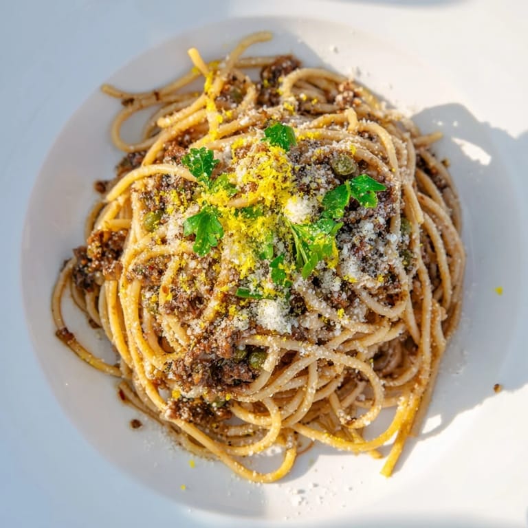 Freshly made Olive Tapenade Pasta with vibrant green parsley, ready to be enjoyed.