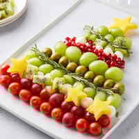 Christmas Tree Triangle Board: A festive appetizer with green grapes, olives, kiwi and sparkling pomegranate.