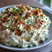 Creamy roasted garlic cream cheese spread with fresh chives, perfect for bagels or crackers.  